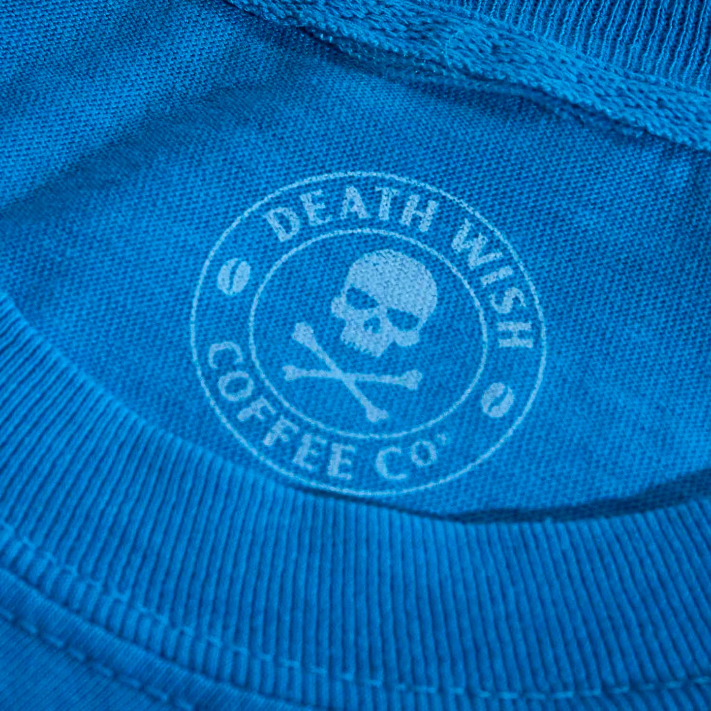 The inner neck label of the Death Wish Coffee Bury Your Blues Tee.