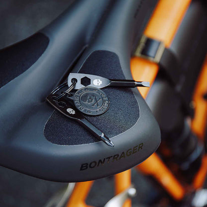The Death Wish Coffee Roadside Revival Keyring sitting on a bike seat.