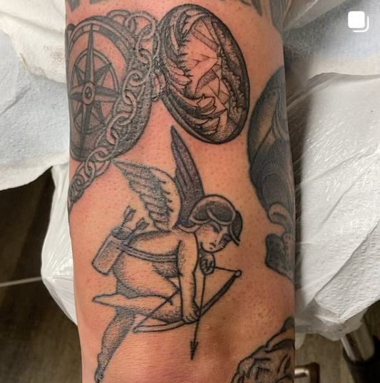 A picture of a cherub tattoo done by Peter Clarke of Dead Presidents Lounge.