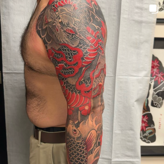 A picture of a recent tattoo done by Peter Clarke of Dead Presidents Lounge using red and black ink.